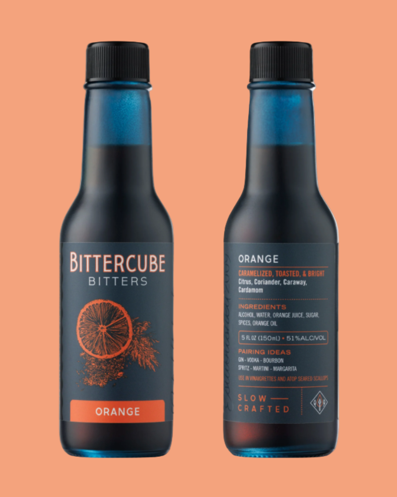 Two bottles of Bittercube Orange bitters on an orange background