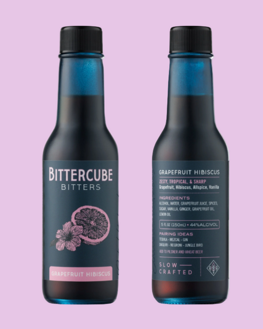 Two bottles of Bittercube Bitters on a pink background