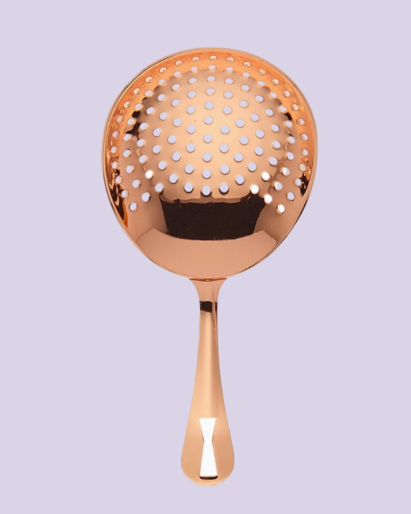 Rose gold kitchen skimmer on a white background