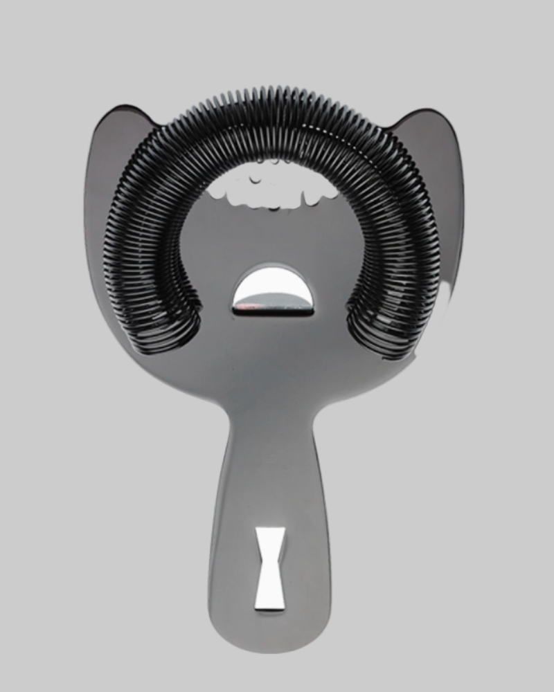 Metallic cocktail shaker with black coiled strainer on a light gray background