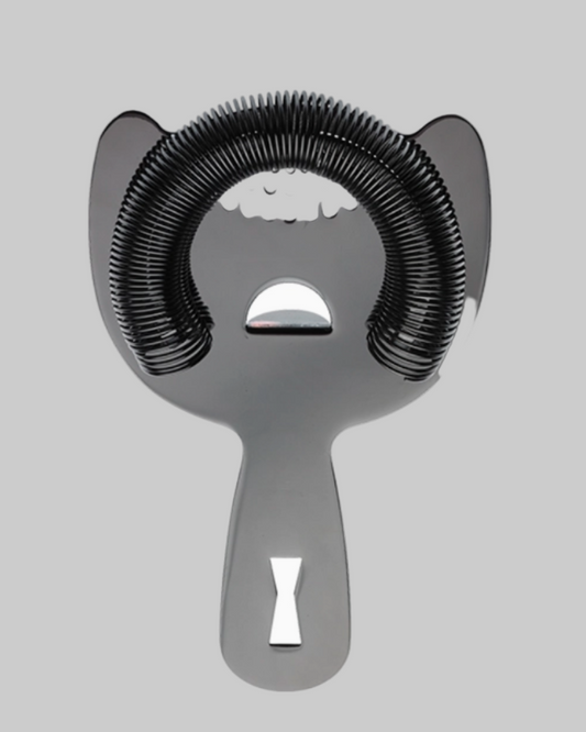 Metallic cocktail shaker with black coiled strainer on a light gray background