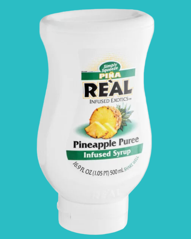Bottle of Pina Real Pineapple Puree Syrup on a teal background