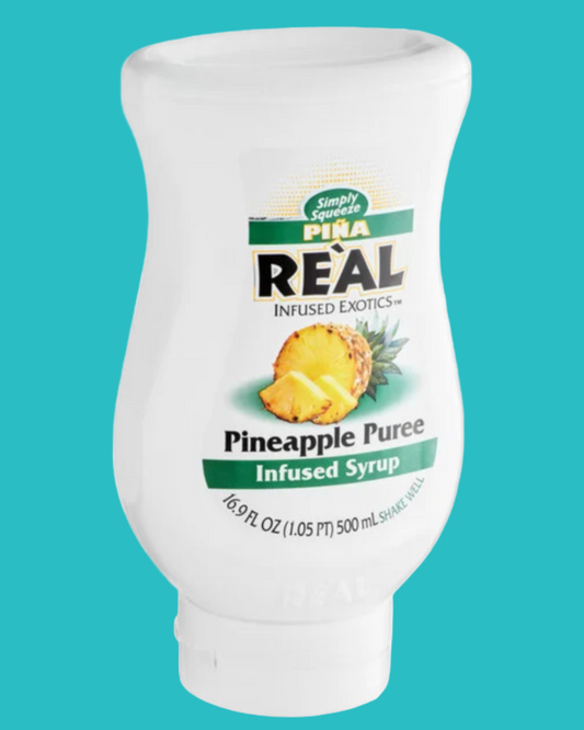 Bottle of Pina Real Pineapple Puree Syrup on a teal background