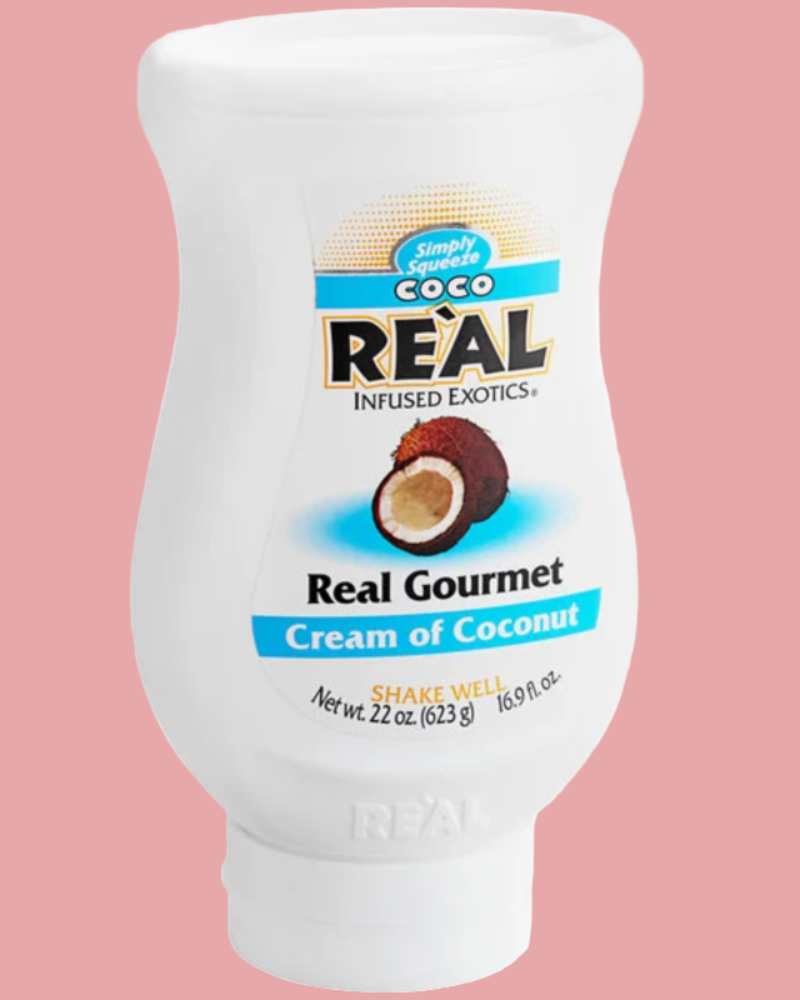 Real Gourmet Cream of Coconut bottle on a pink background