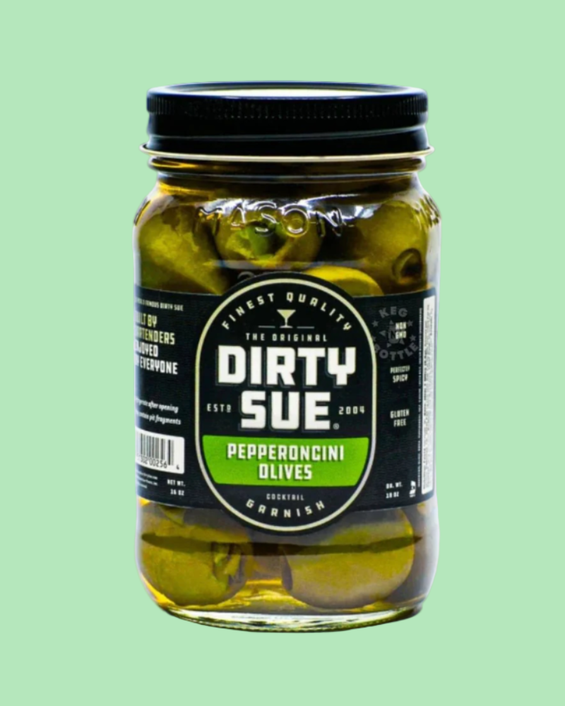 Jar of Dirty Sue pepperoncini olives on a green background