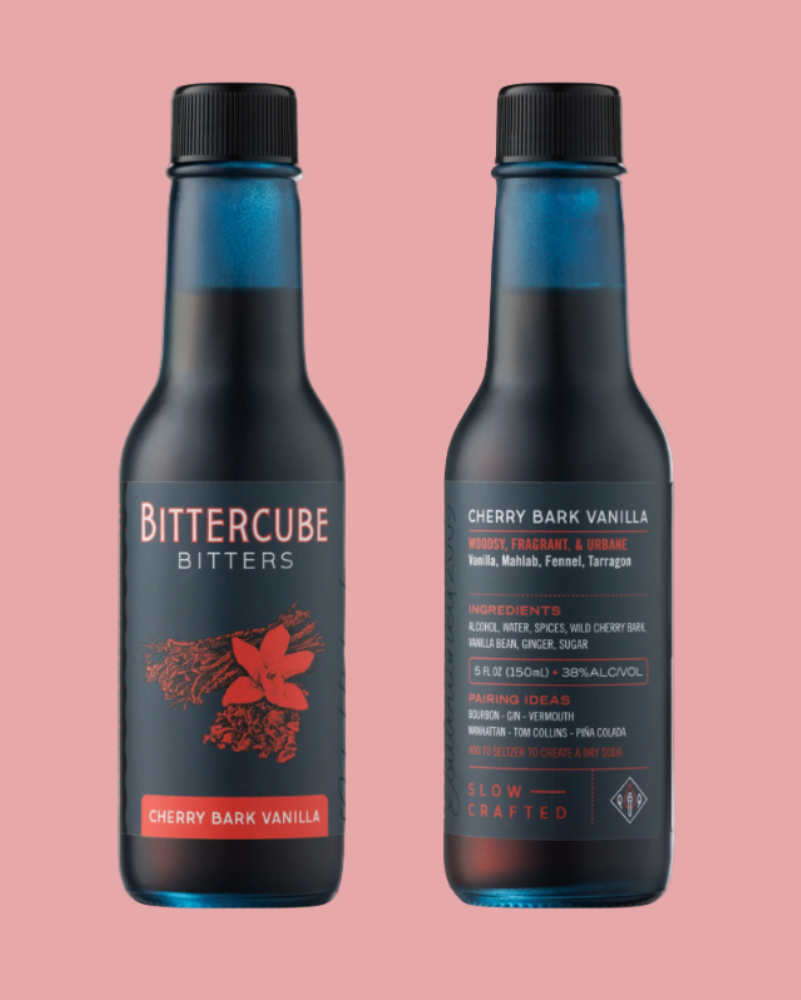 Two bottles of Bittercube Bitters on a pink background
