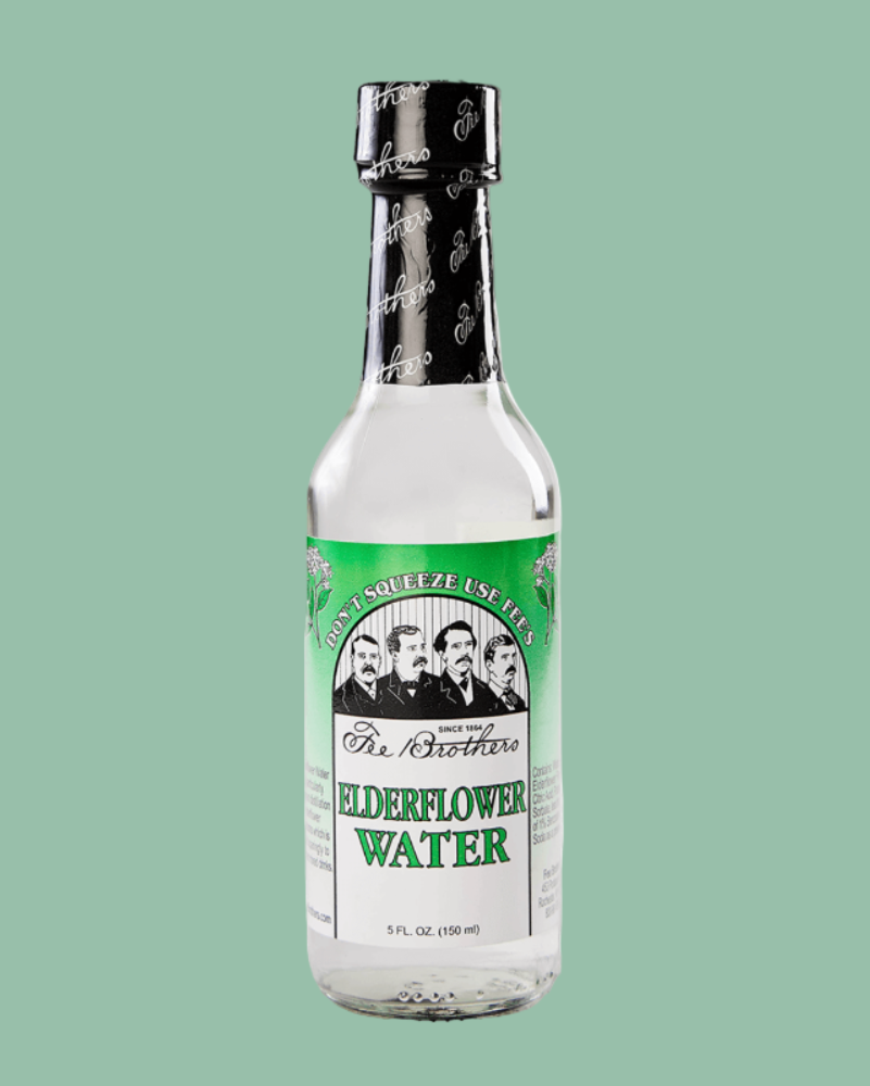Bottle of elderflower water with a green label on a light green background