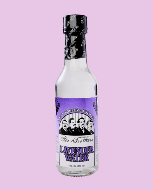 Bottle of lavender water with a purple label on a pink background