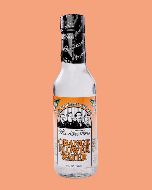 Bottle of 'The Brothers' Orange Flower Water on a peach background