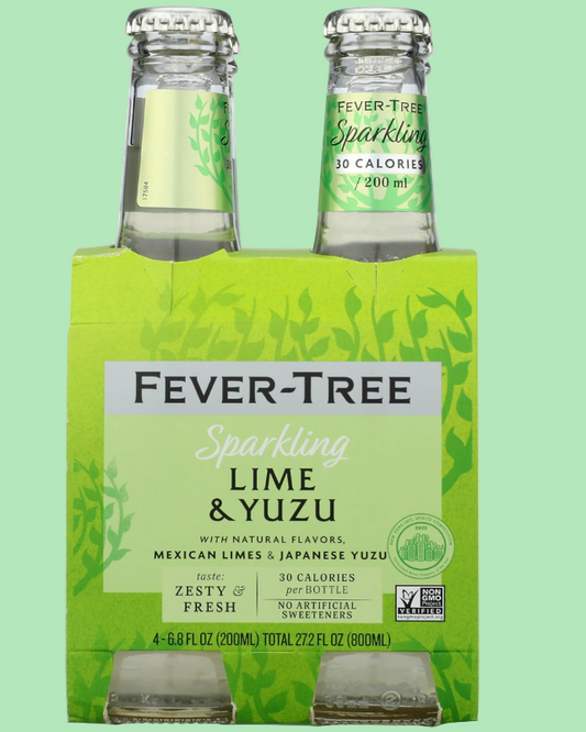 Pack of Fever-Tree Sparkling Lime & Yuzu bottles on a green background