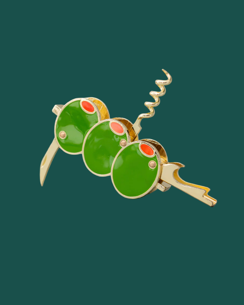 Brooch with green and red circular design on a dark green background