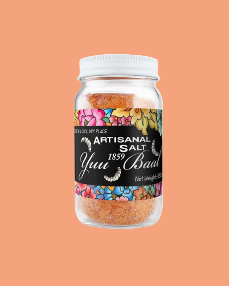 Jar of Artisanal Salt with colorful label on a peach background