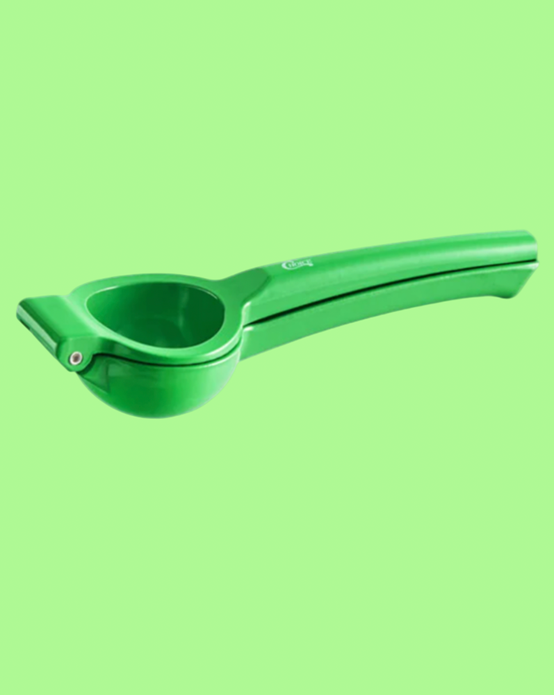 green garlic press on llight green background