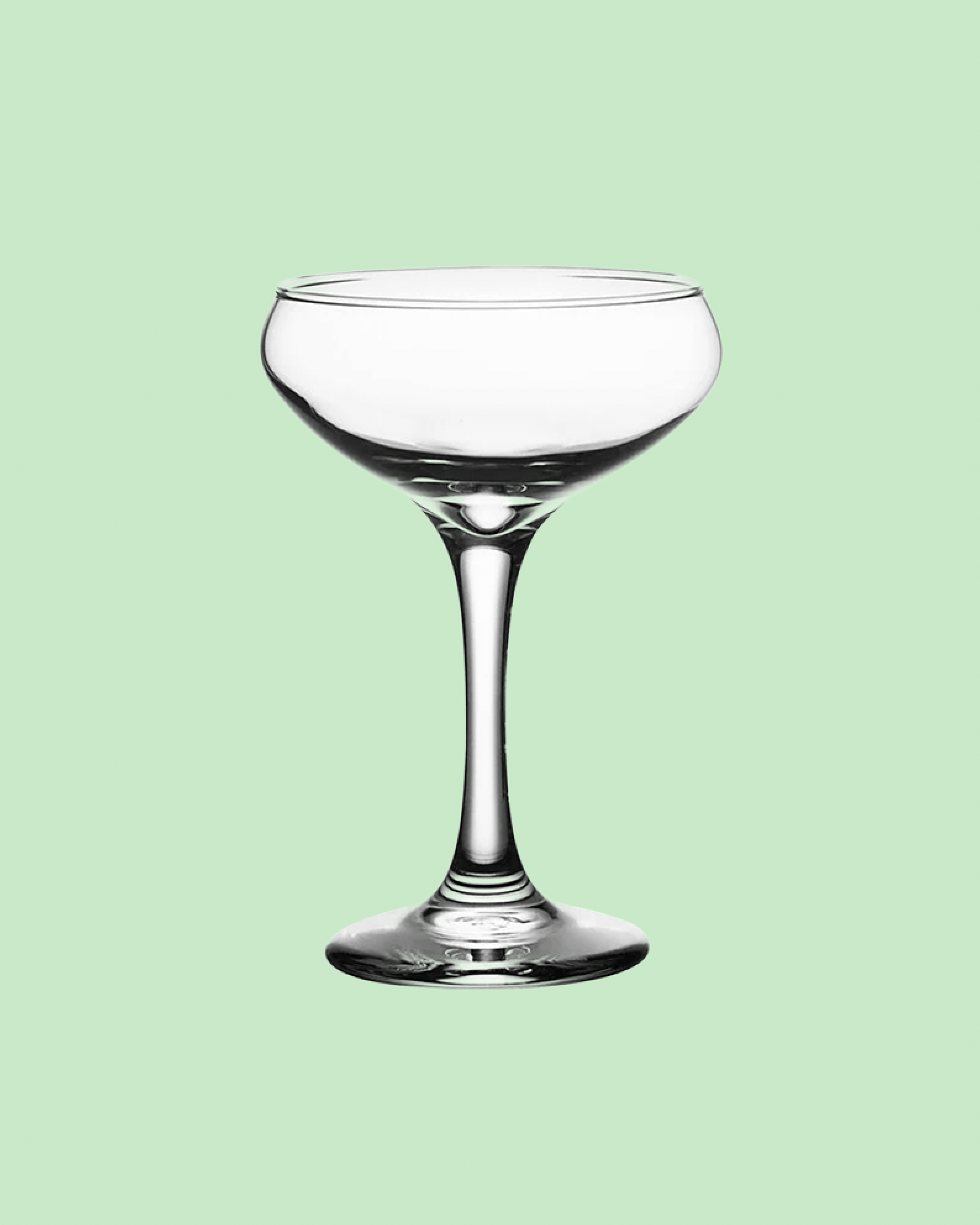 tall coupe wine glass on a green background