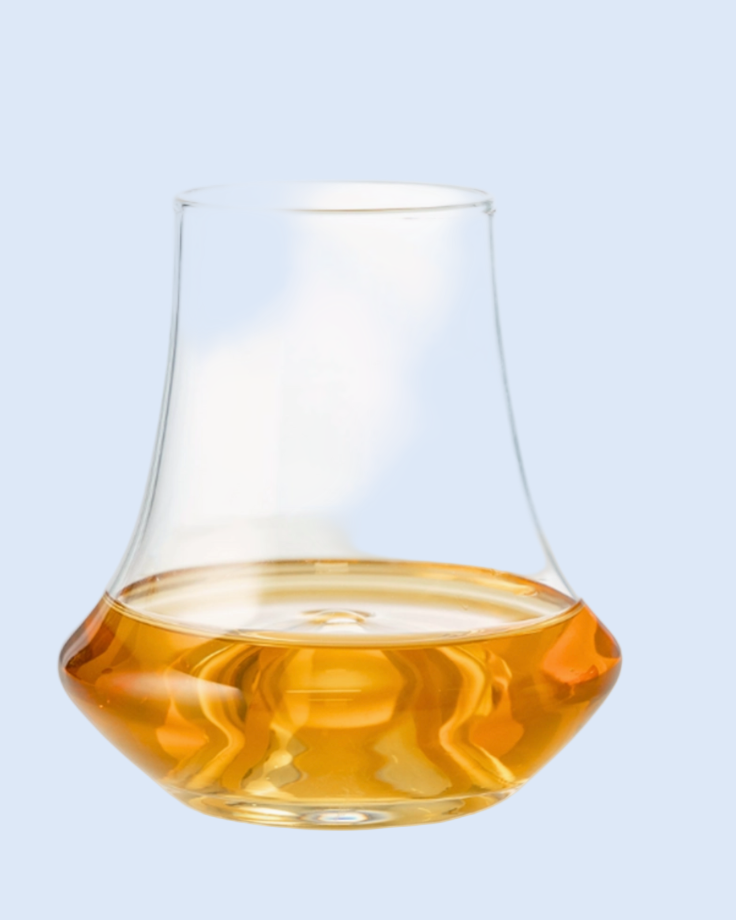 Clear glass with amber liquid on a white background