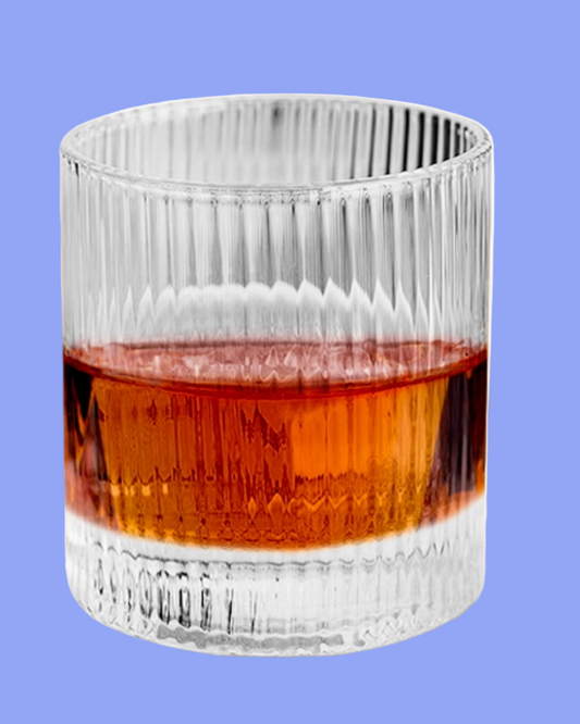 Clear glass with amber liquid on a blue background