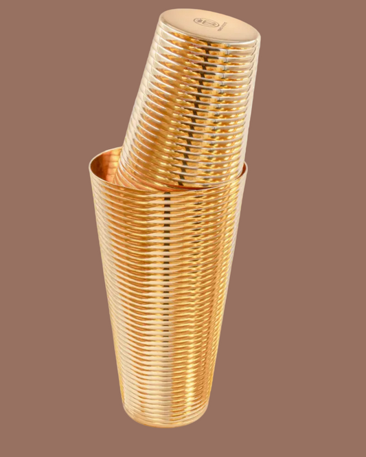 Stack of gold plastic cups on a brown background