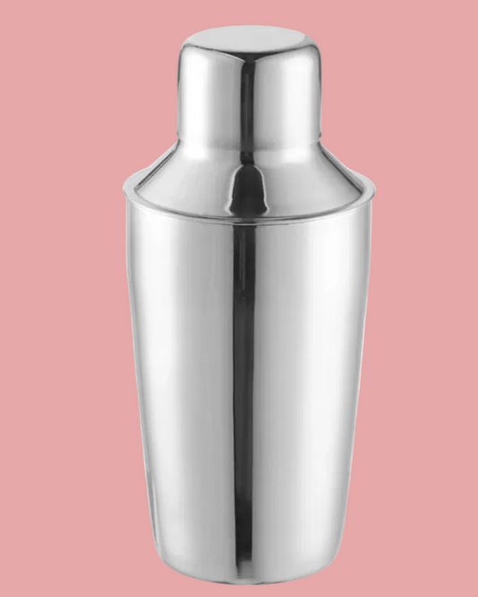 Stainless steel cocktail shaker on a pink background