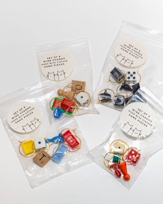 Set of mini game pieces in clear packaging on a white background