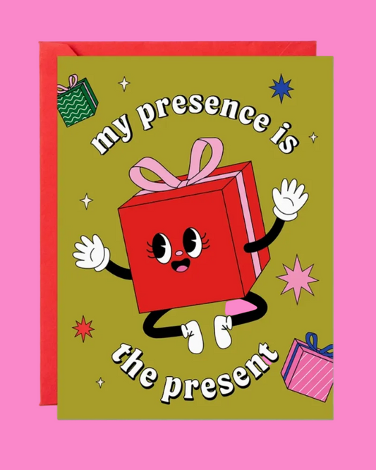 Card with a cartoon red gift box character and text 'my presence is the present' on a pink background