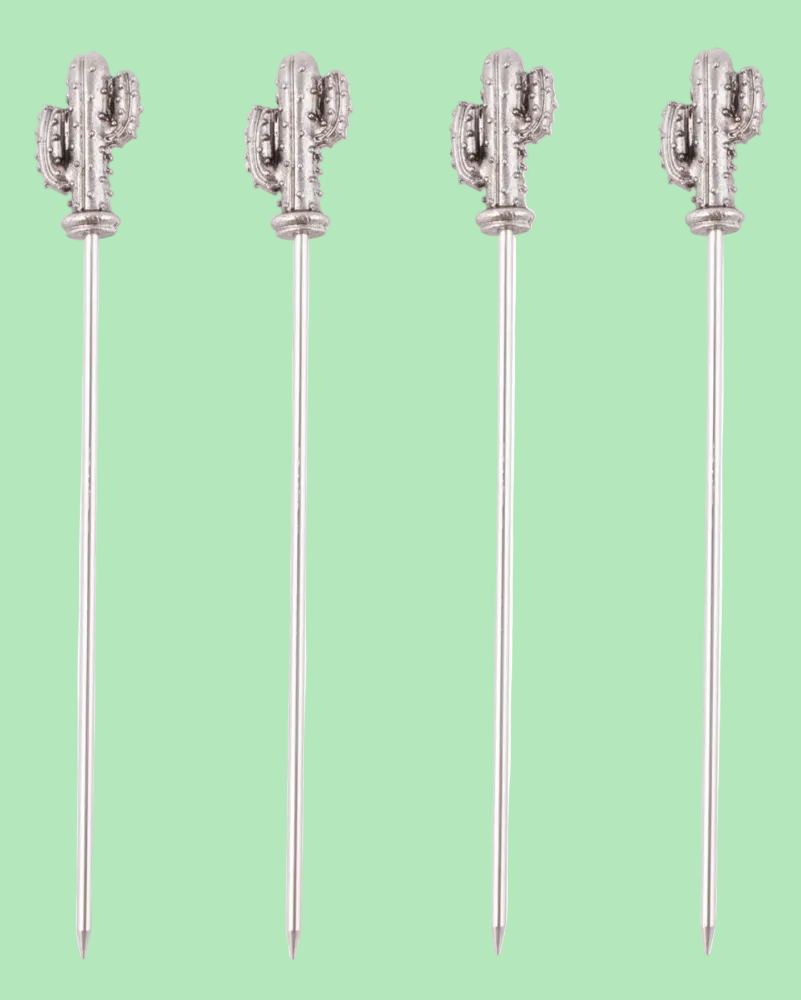 Four cactus-shaped cocktail picks on a light green background