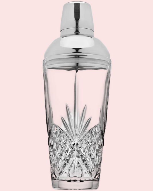 Cocktail shaker with silver top on a pink background