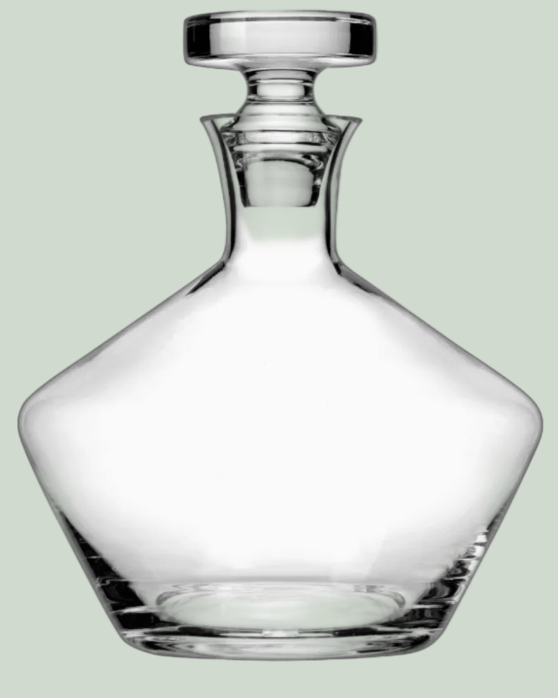 Clear glass decanter on a light green background