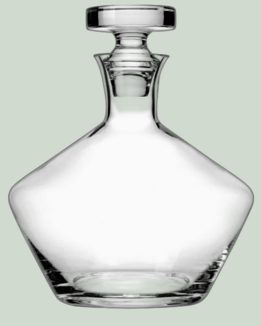 Clear glass decanter on a light green background
