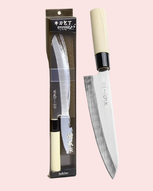 Sekiho knife with packaging on a light pink background