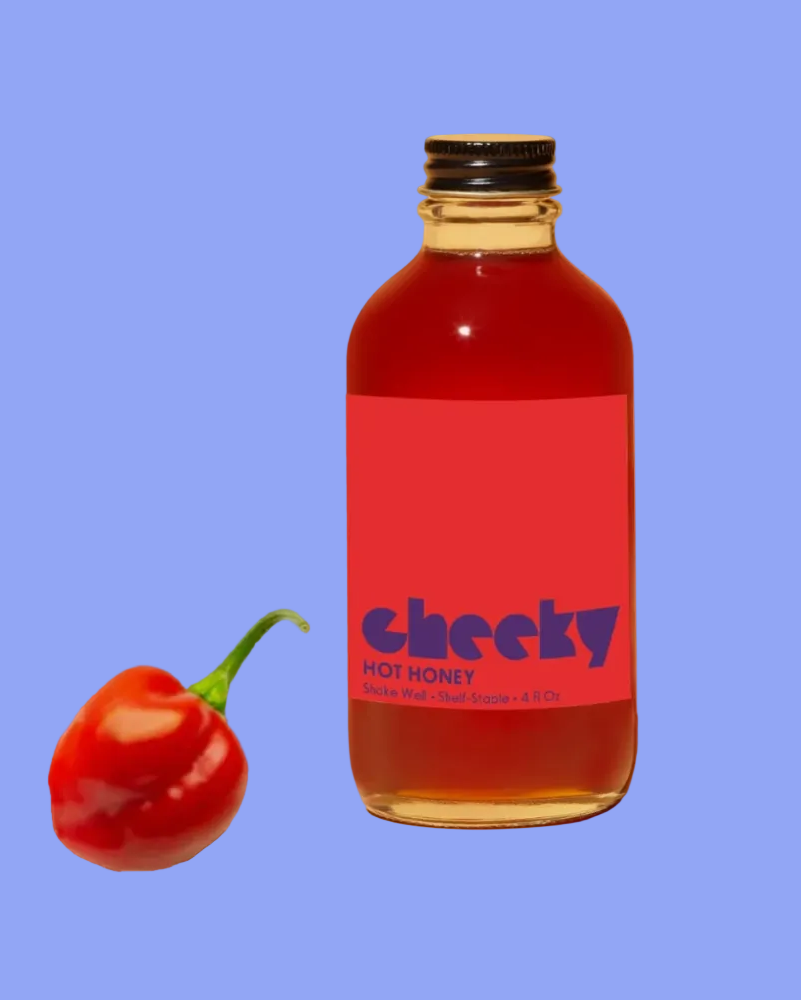 Bottle of 'Cheeky' hot honey with a red label and a chili pepper on a blue background