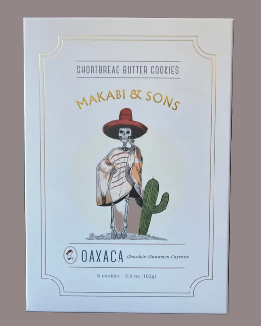 Packaging of Makabi & Sons shortbread butter cookies with a skeleton and cactus illustration on a light blue background.