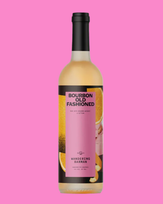 Bottle of Bourbon Old Fashioned on a pink background