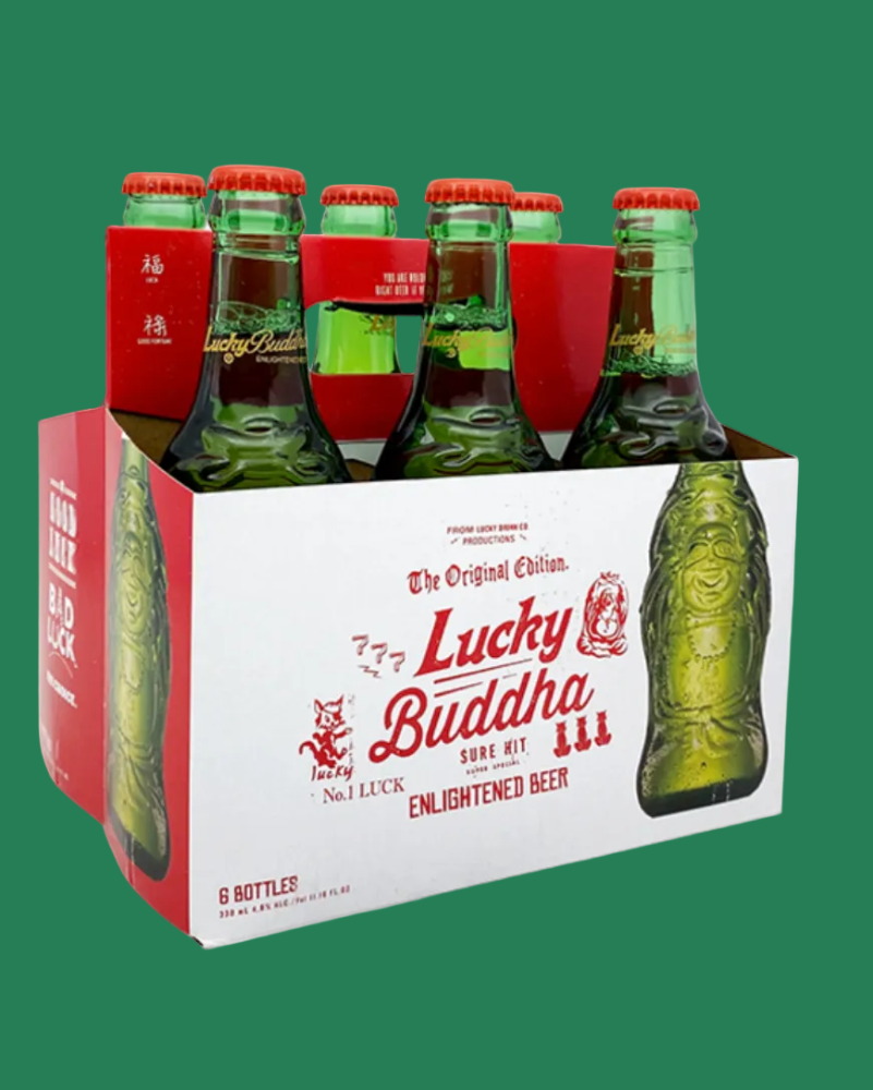 Six-pack of Lucky Buddha beer bottles in a cardboard holder on a green background