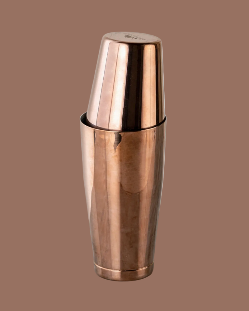 Copper cocktail shaker on a brown background