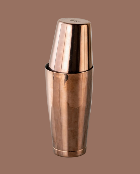 Copper cocktail shaker on a brown background