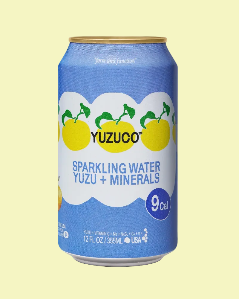 Yuzuco sparkling water can with blue label and yuzu fruit illustration on a white background
