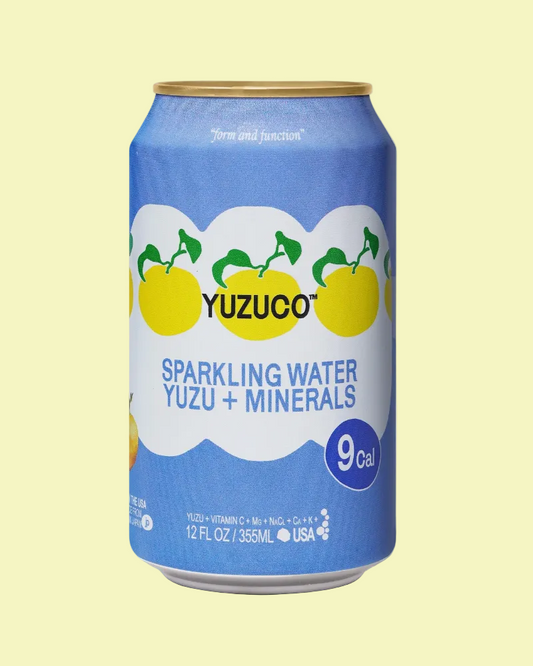 Yuzuco sparkling water can with blue label and yuzu fruit illustration on a white background