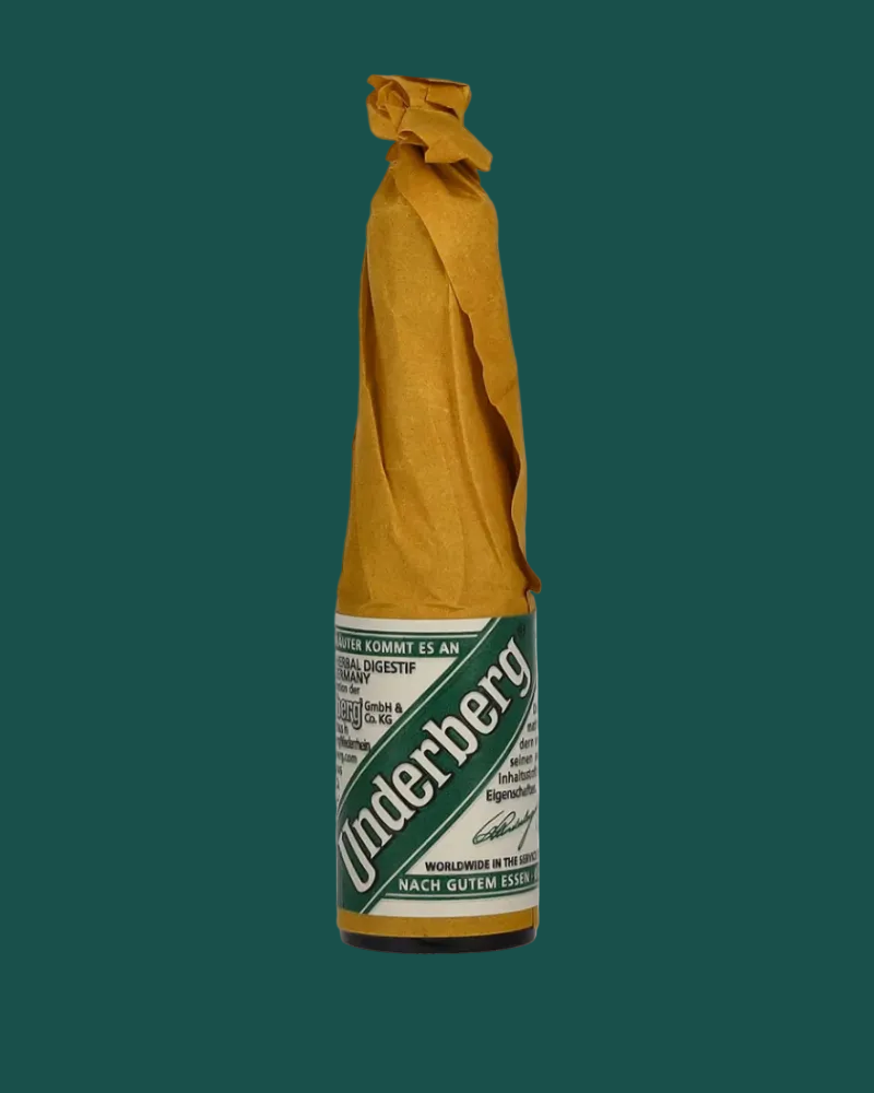Underberg bottle with green label on a white background
