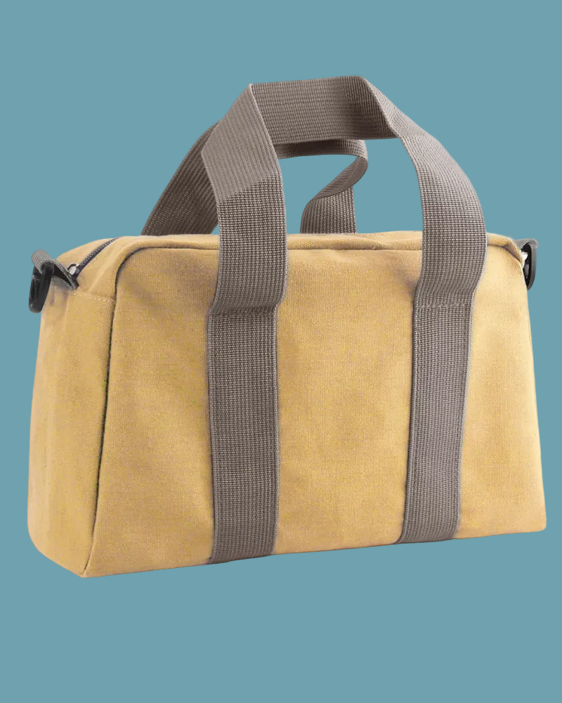 Beige duffel bag with brown straps on a white background