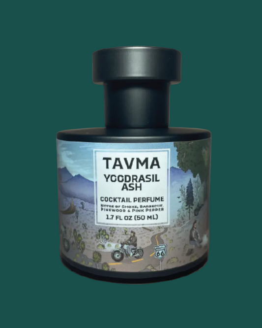 Perfume bottle with a label featuring artistic designs and text on a beige background
