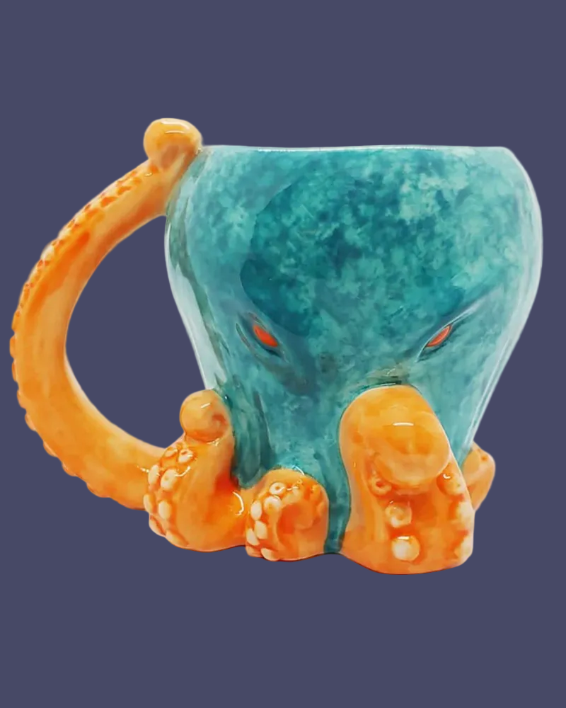 Turquoise mug with orange octopus handle and tentacles on a dark blue background