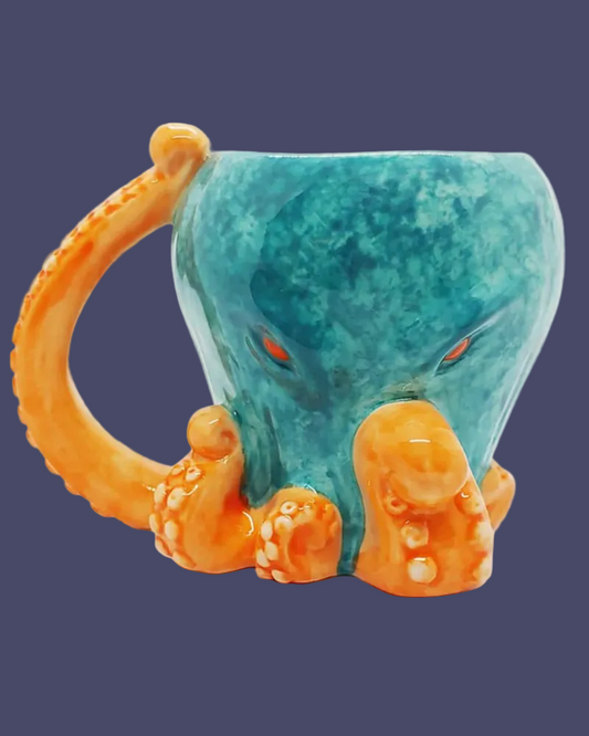 Turquoise mug with orange octopus handle and tentacles on a dark blue background