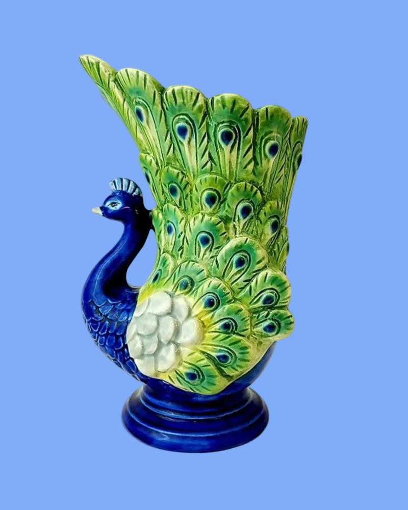 Decorative vase shaped like a peacock on a blue background