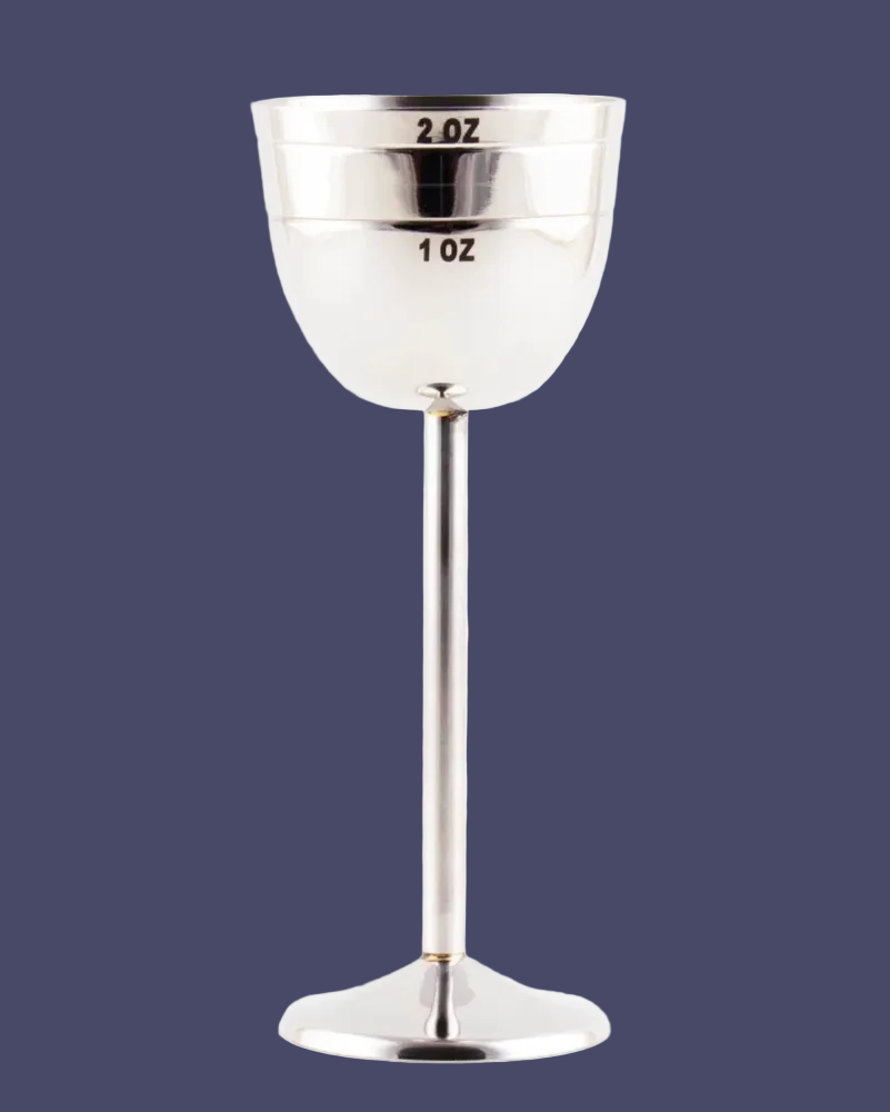 Silver jigger measuring tool on a dark blue background