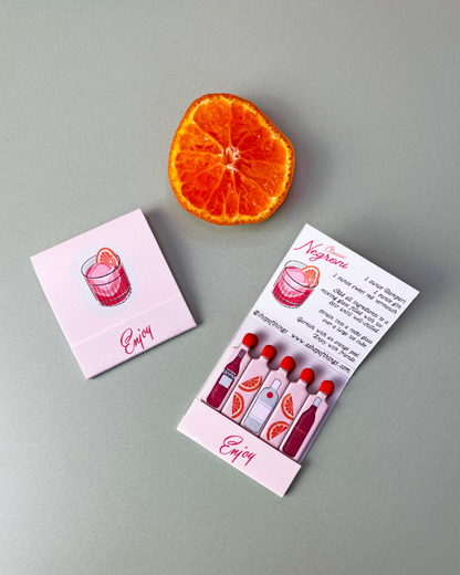 Two business cards with a drink illustration and an orange slice on a gray background