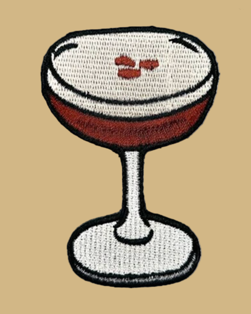 Patch of a cocktail glass with a white foam top on a white background