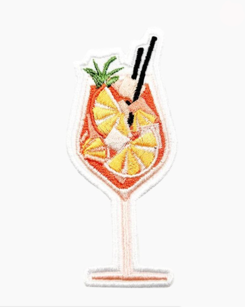 Embroidered patch of a cocktail with lemon slices and a straw on a white background