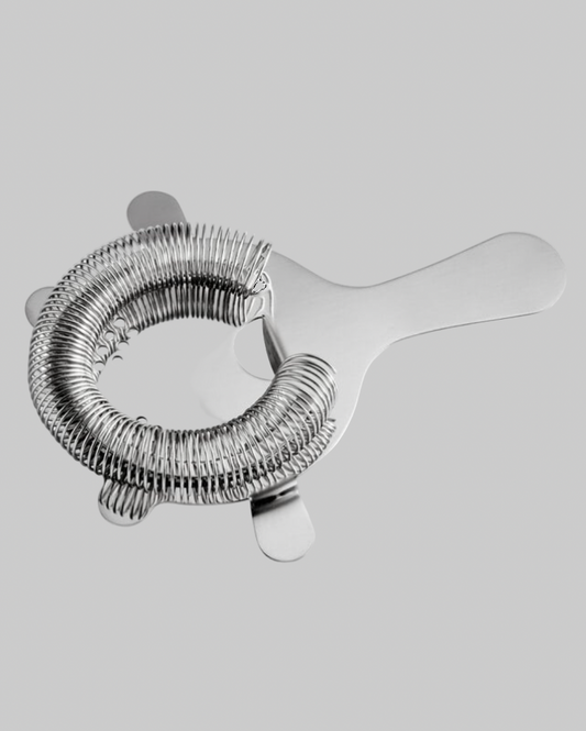 silver metal strainer on a grey background