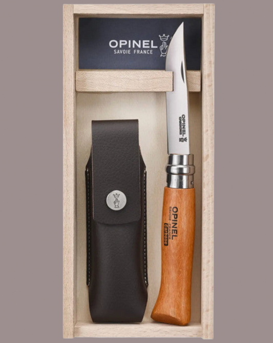 Opinel knife in wooden box with sheath on a grey background