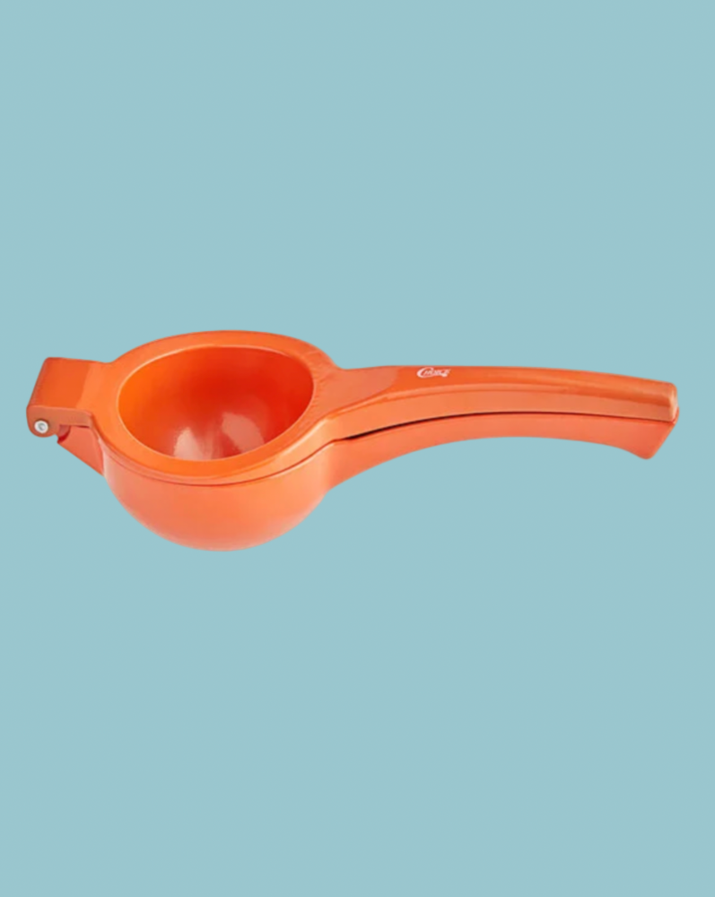 Orange citrus squeezer on a light blue background